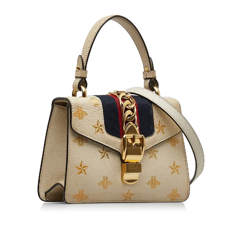 Women Gucci Sylvie bags with a crystal - embellished web stripeGUCCI Mini Sylvie Bee Star Top Handle Bag