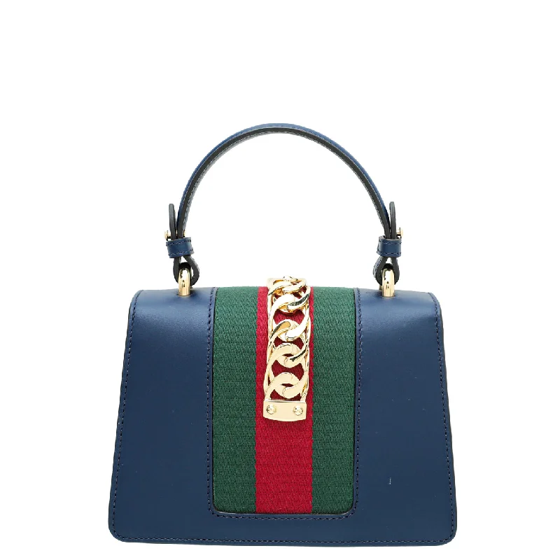 Women Gucci tote bags in GG Supreme canvas for a branded feelGucci Navy Blue Sylvie Mini Top Handle Bag